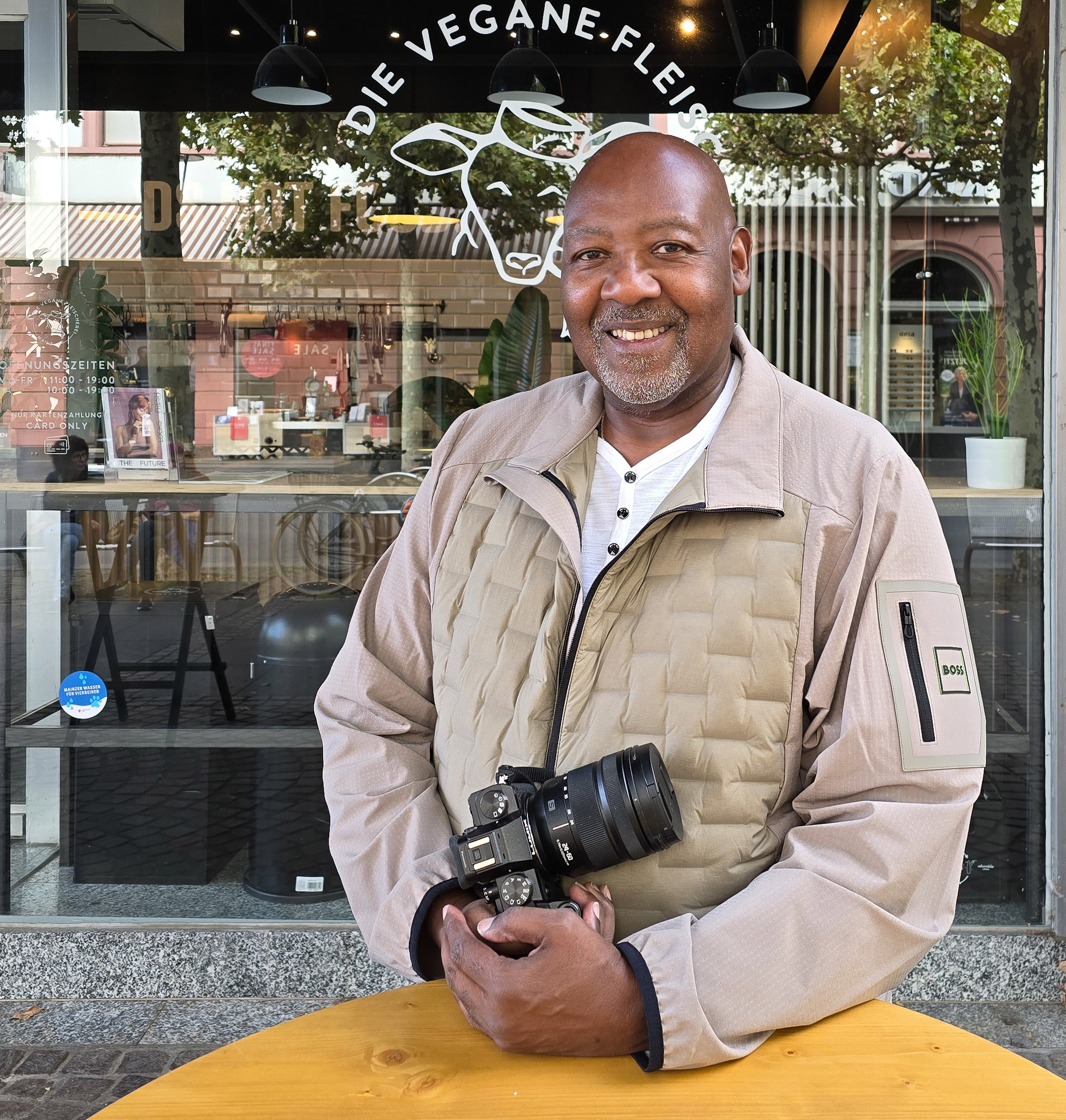 Derek Bembry smiling with his camera